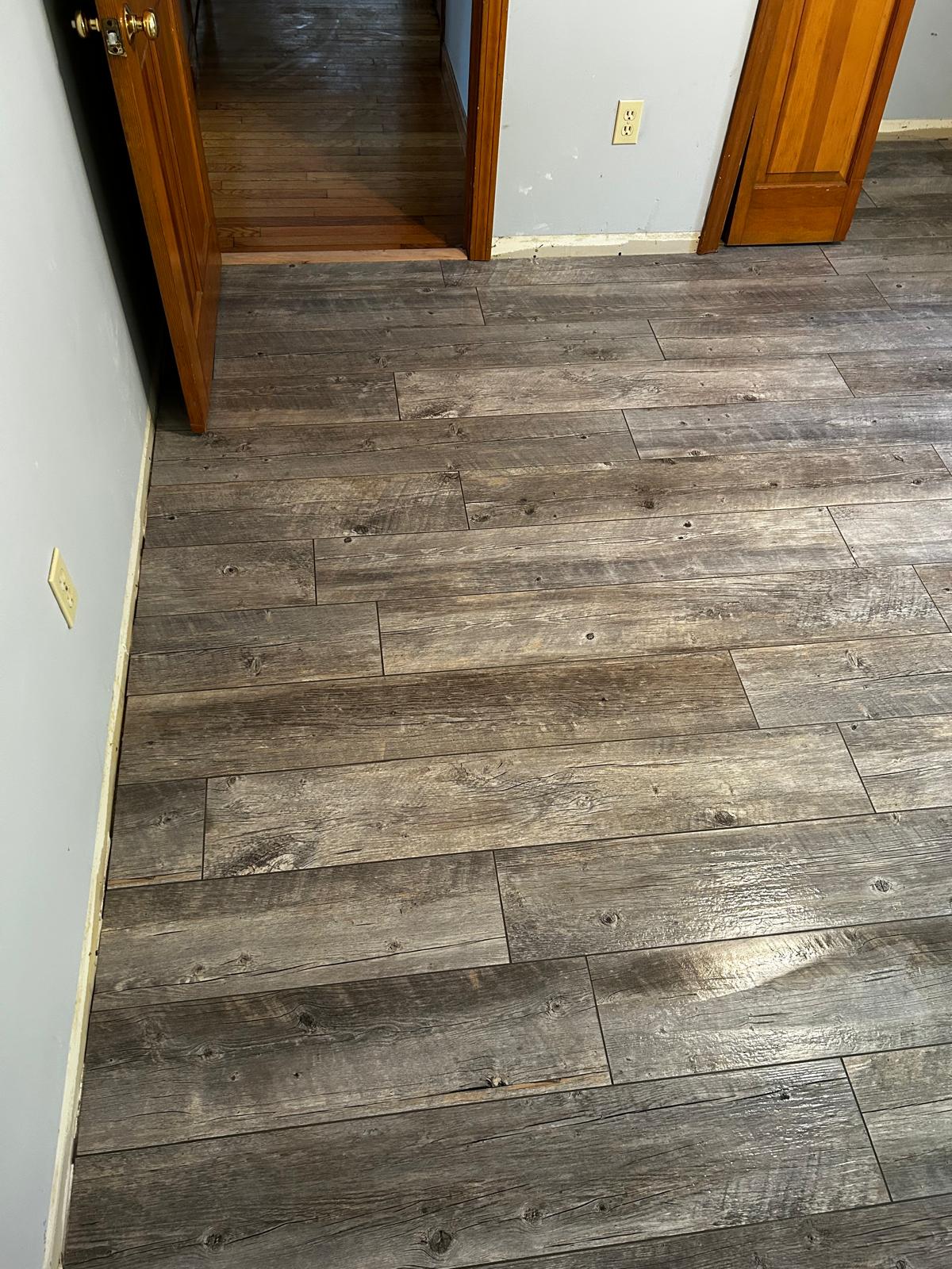 Completed wood-look tile flooring installation by Luxe Revamp