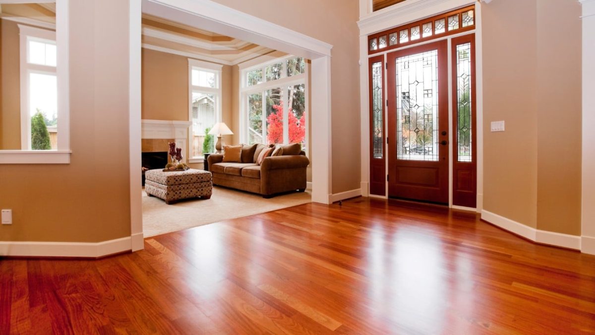 Polished hardwood flooring across an elegant sunlit entryway
